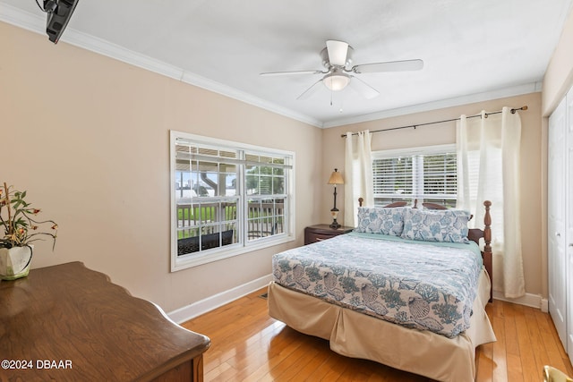 bedroom with multiple windows, a closet, and light wood-type flooring