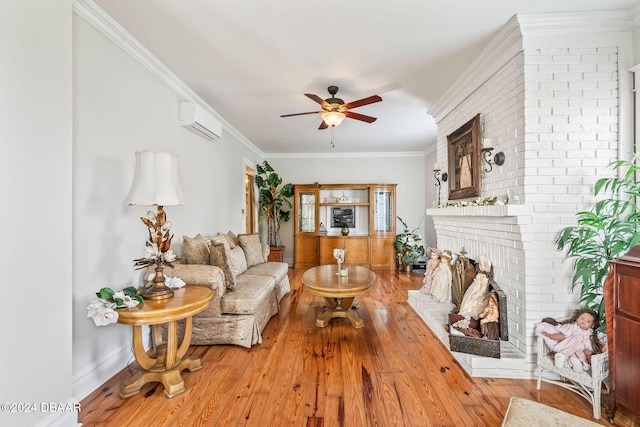 living room with ceiling fan, a brick fireplace, an AC wall unit, crown molding, and light wood-type flooring