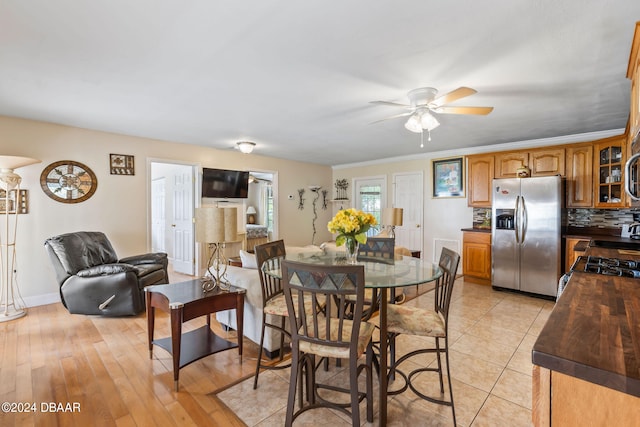 dining space with ceiling fan, light hardwood / wood-style flooring, and ornamental molding