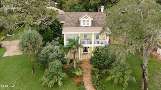 exterior space featuring a front yard, a porch, and a balcony