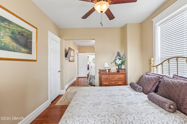 bedroom with ceiling fan and dark hardwood / wood-style flooring