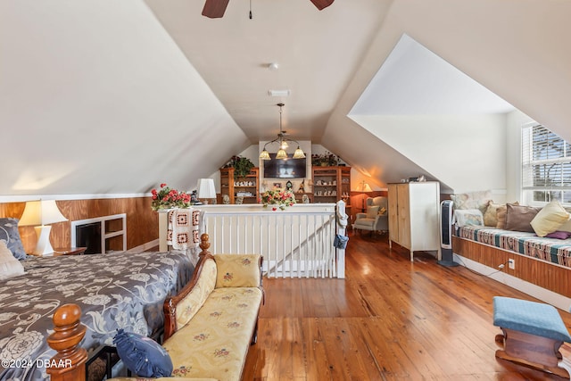 bedroom featuring ceiling fan, wood-type flooring, and lofted ceiling