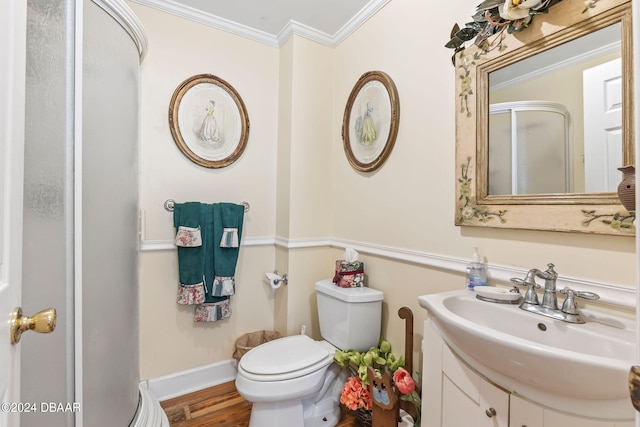 bathroom with wood-type flooring, vanity, toilet, and ornamental molding