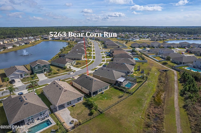 birds eye view of property with a water view