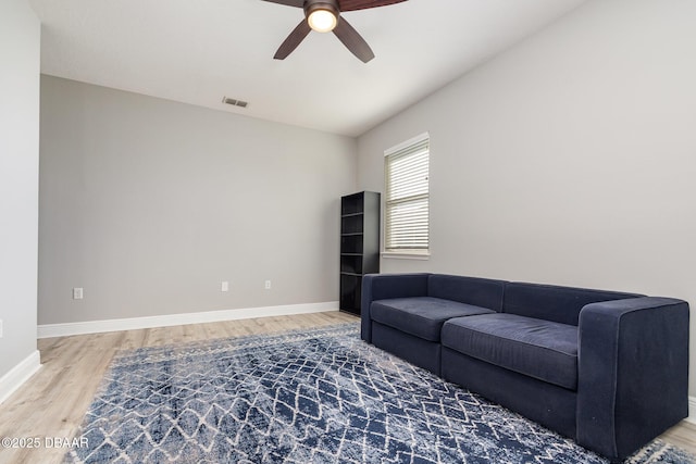 living room featuring hardwood / wood-style floors and ceiling fan