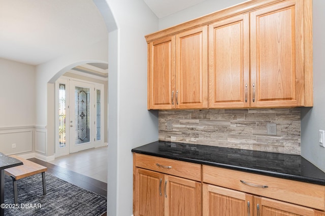 bar featuring hardwood / wood-style floors and backsplash