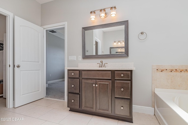 bathroom featuring vanity, a bath, and tile patterned flooring