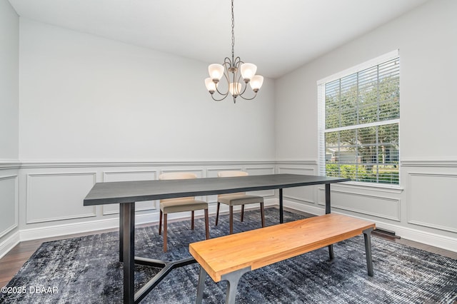 dining room featuring dark wood-type flooring and a notable chandelier