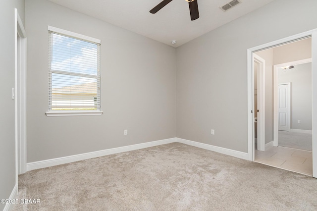 unfurnished room featuring light carpet and ceiling fan