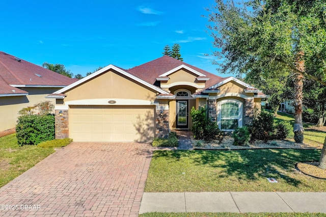 single story home with a garage and a front lawn