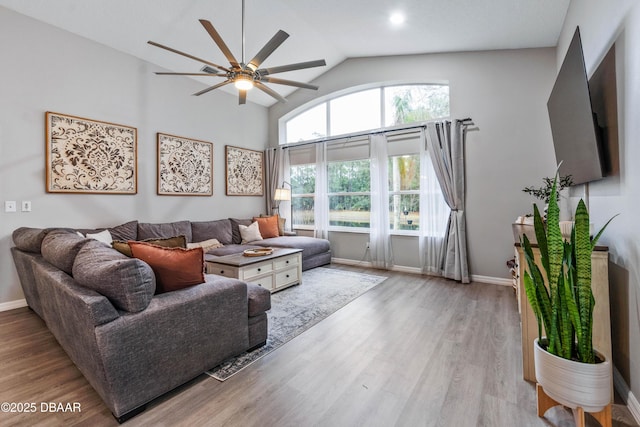 living room featuring ceiling fan, wood finished floors, and baseboards