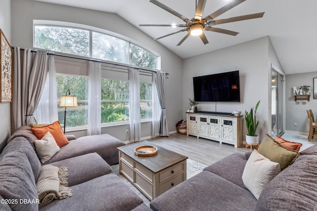 living room featuring high vaulted ceiling, baseboards, a ceiling fan, and wood finished floors