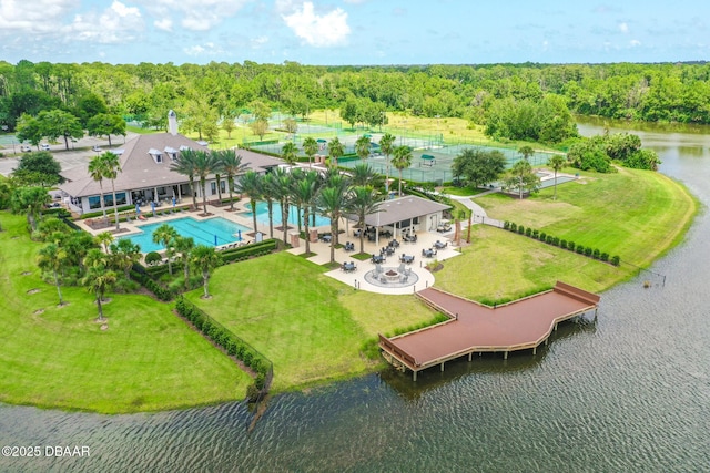 birds eye view of property featuring a water view and a view of trees