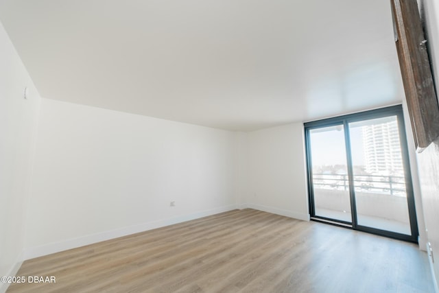 spare room with light hardwood / wood-style flooring