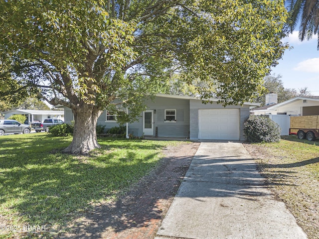 view of front of home with a garage, a front yard, driveway, and fence