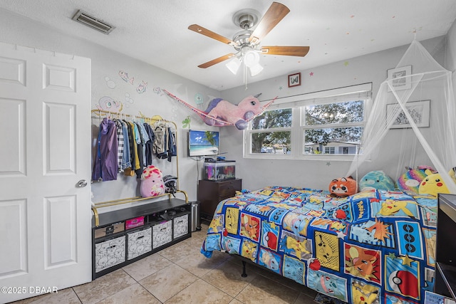 tiled bedroom featuring ceiling fan and visible vents