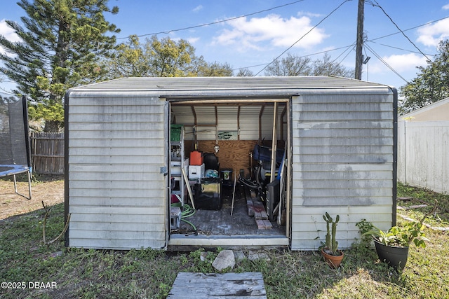 view of shed featuring a fenced backyard and a trampoline