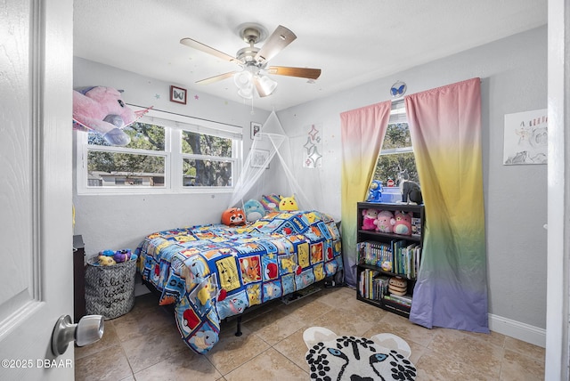 bedroom featuring ceiling fan and baseboards