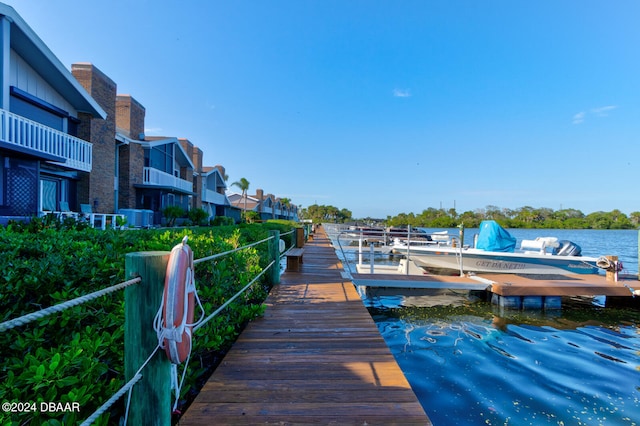 view of dock featuring a water view and cooling unit