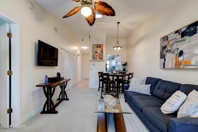 living room featuring ceiling fan with notable chandelier, lofted ceiling, and light carpet