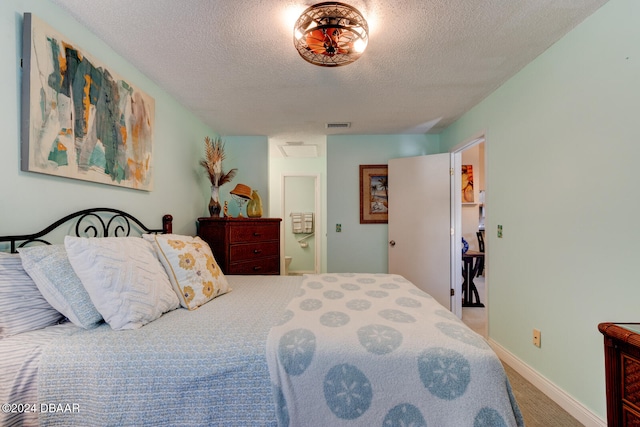 carpeted bedroom featuring a textured ceiling