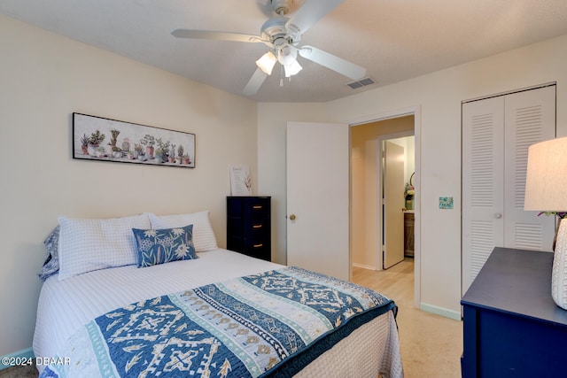 bedroom with a closet, ceiling fan, and light colored carpet