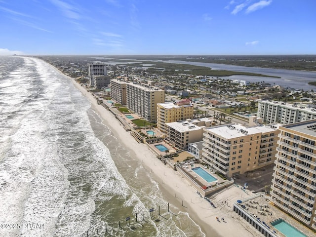 aerial view with a water view, a view of the beach, and a city view