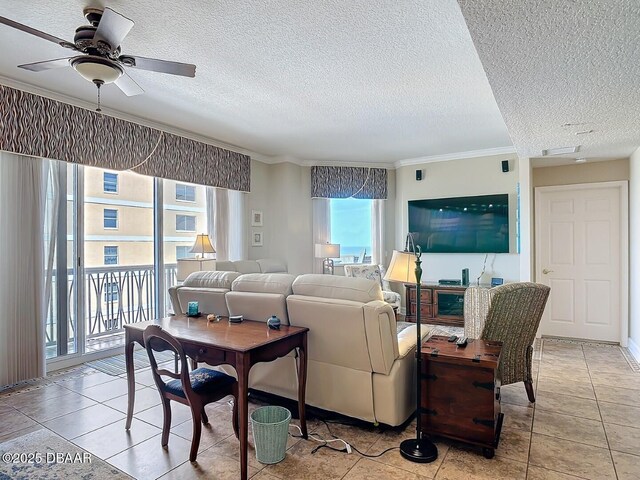 tiled living area with a textured ceiling, a ceiling fan, and crown molding