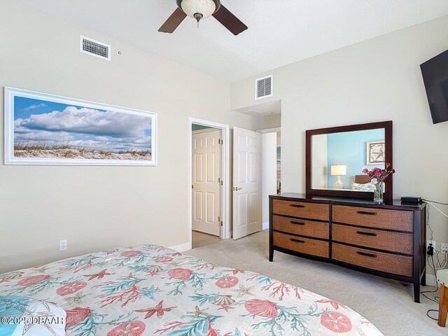 bedroom featuring a ceiling fan, visible vents, light carpet, and baseboards