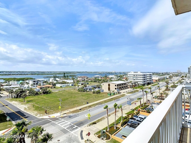 balcony featuring a water view and a city view