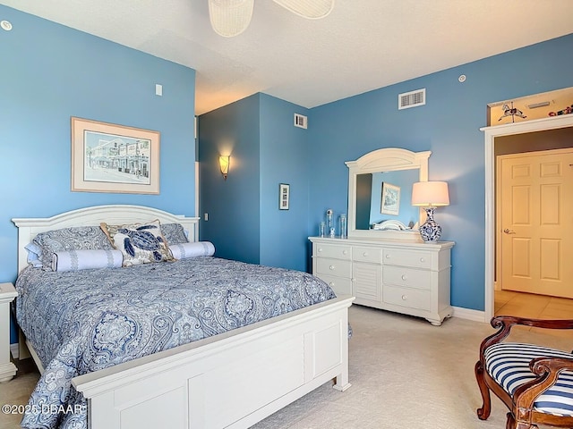 bedroom featuring light carpet, visible vents, and baseboards