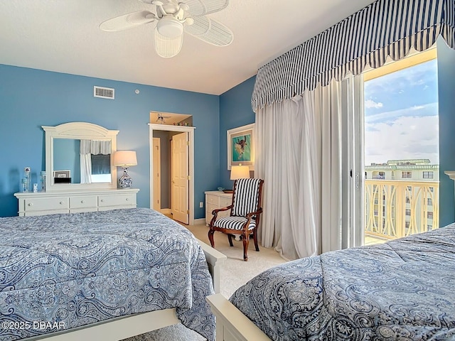 bedroom featuring access to exterior, visible vents, carpet floors, and a ceiling fan