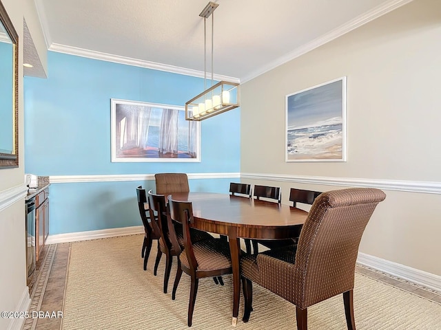 dining area with baseboards, an inviting chandelier, and crown molding