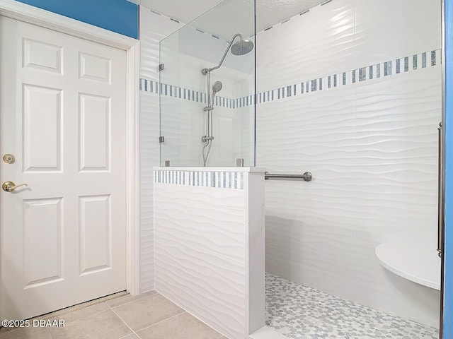 full bathroom featuring tile patterned flooring and walk in shower