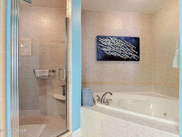 full bathroom with a shower stall, a whirlpool tub, and a textured ceiling