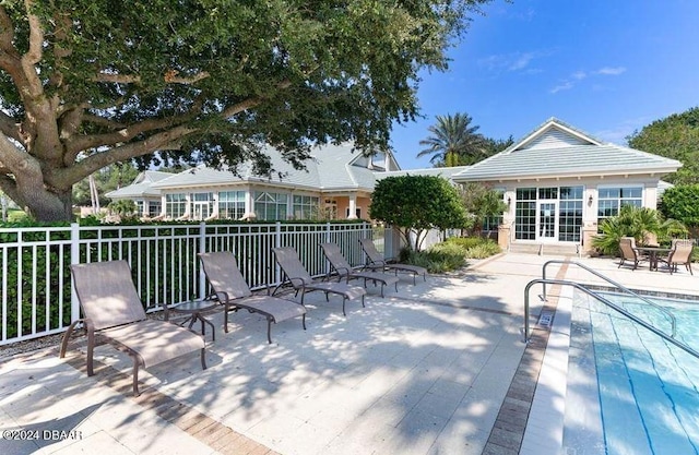 exterior space with a community pool, an outbuilding, and a patio