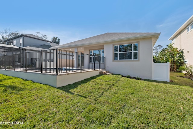 rear view of property with a yard