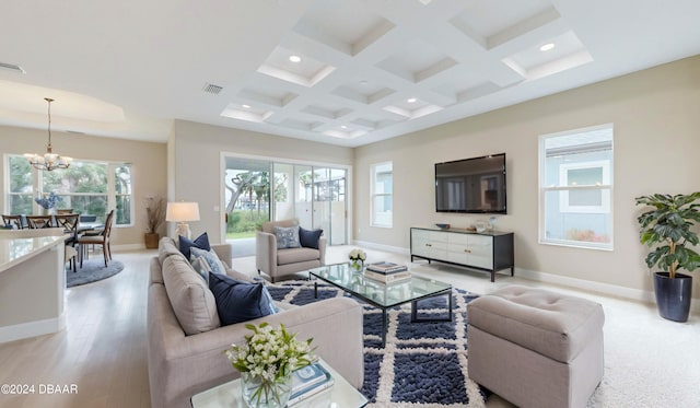 living room with coffered ceiling, light hardwood / wood-style flooring, beamed ceiling, and an inviting chandelier