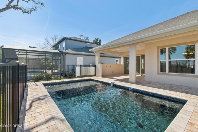 view of pool featuring a patio and glass enclosure