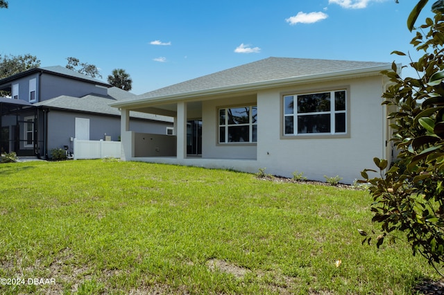 rear view of house with a lawn