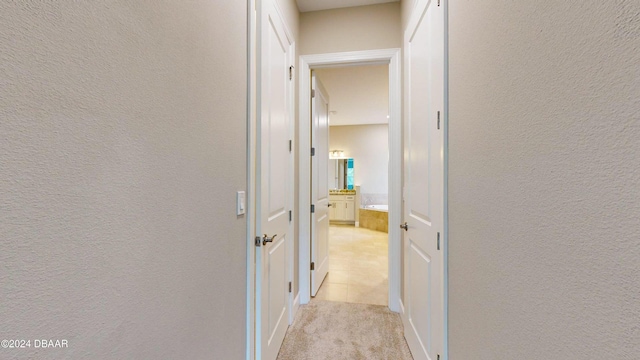 hallway featuring light carpet