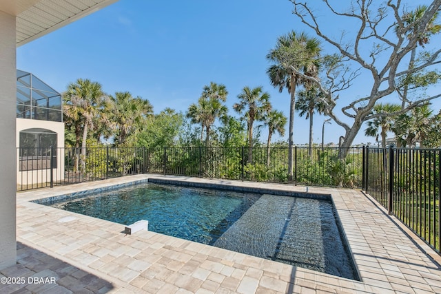 view of pool with a patio and glass enclosure