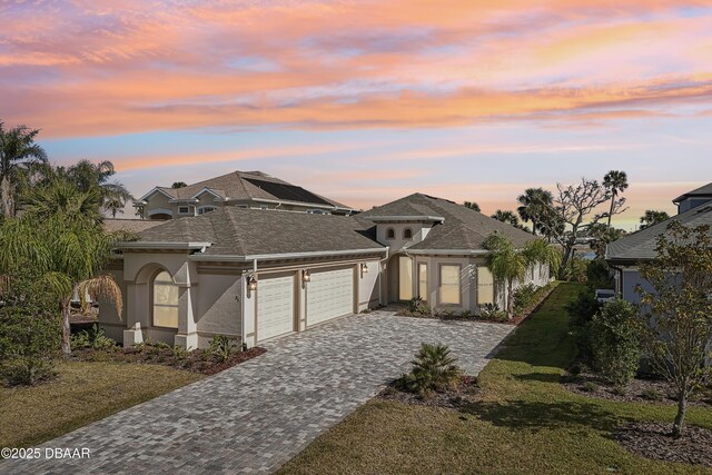 view of front of home with a garage and a front yard