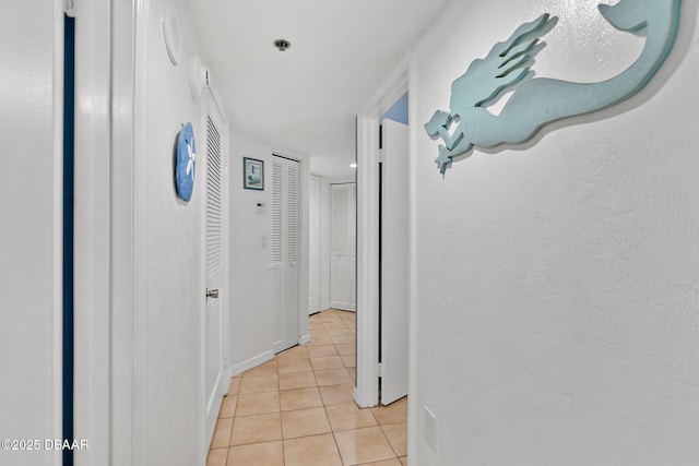 hallway featuring light tile patterned floors