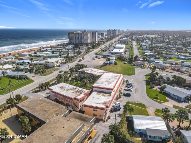 birds eye view of property with a view of the beach and a water view