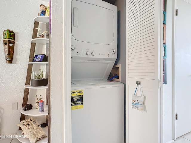 clothes washing area featuring stacked washer / dryer