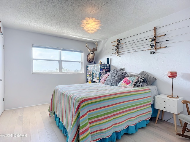 1510 Ocean Shore Blvd Unit 406, Ormond Beach, FL 32176 - bedroom featuring wood finished floors and a textured ceiling