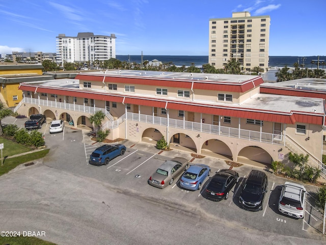 1510 Ocean Shore Blvd Unit 406, Ormond Beach, FL 32176 - view of apartment building / complex with uncovered parking and a water view