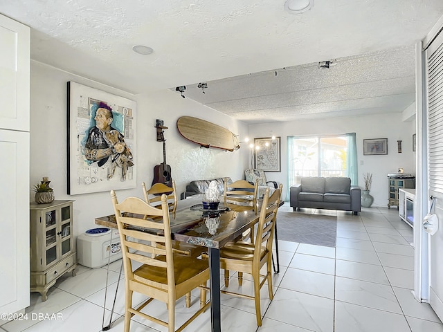 dining space with a textured ceiling