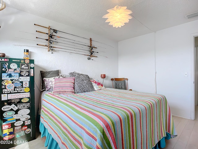 1510 Ocean Shore Blvd Unit 406, Ormond Beach, FL 32176 - bedroom with wood finished floors and a textured ceiling